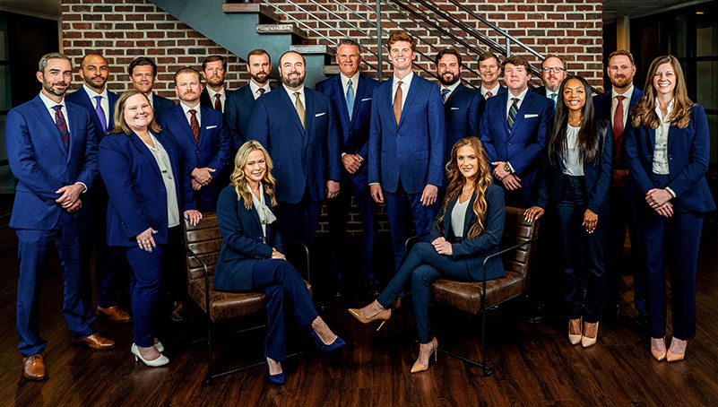 Derrick Law Firm team in front of the office building